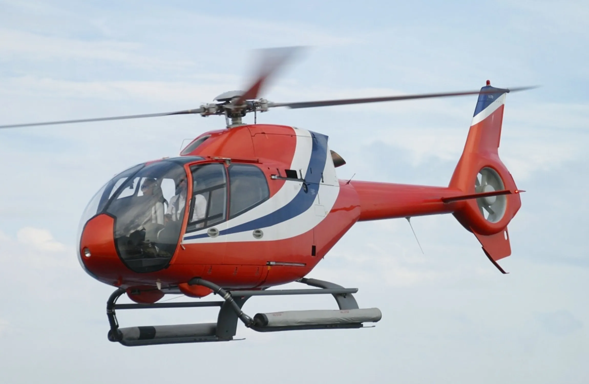 A red helicopter in the air