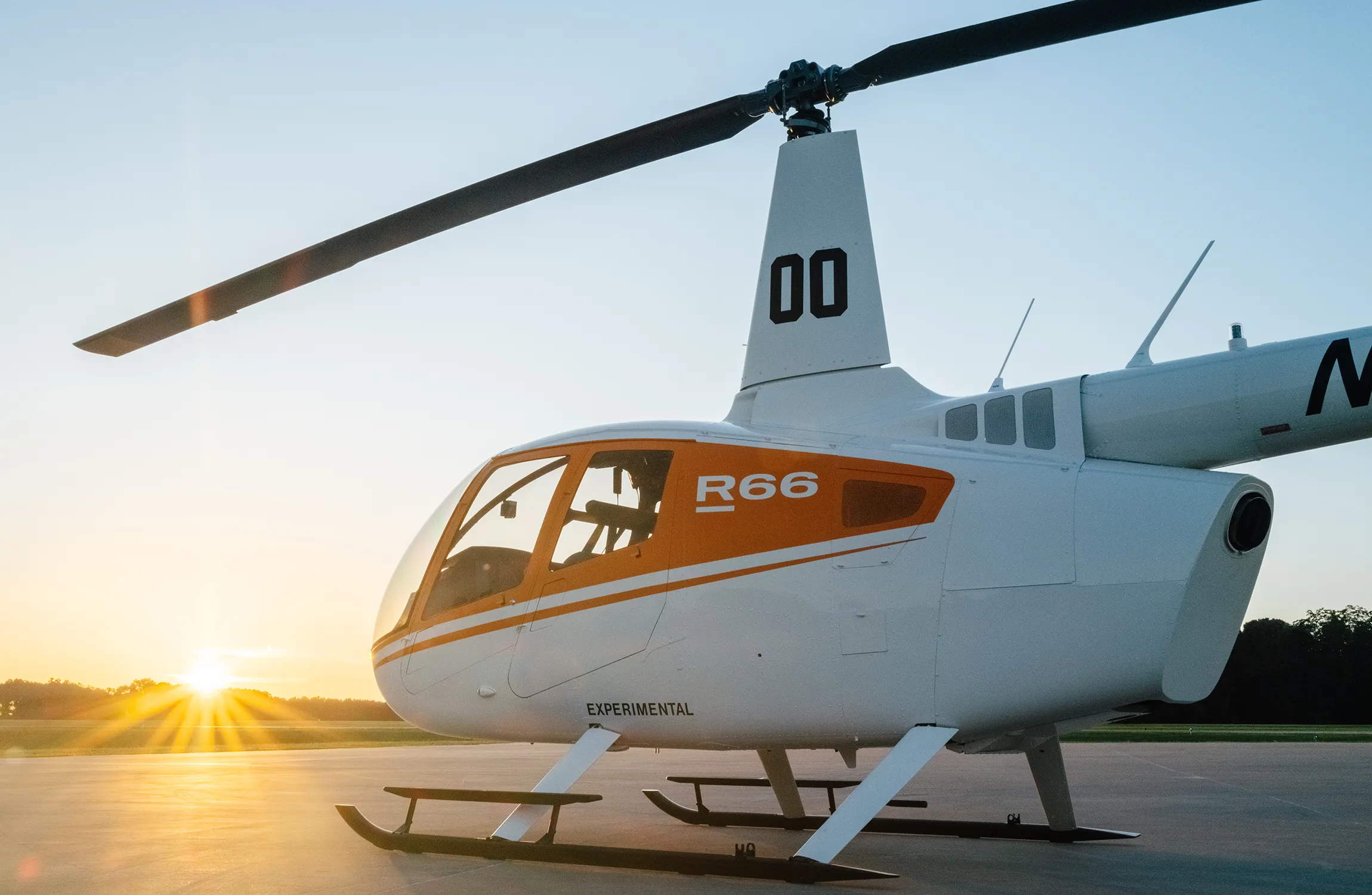A white helicopter on the tarmac