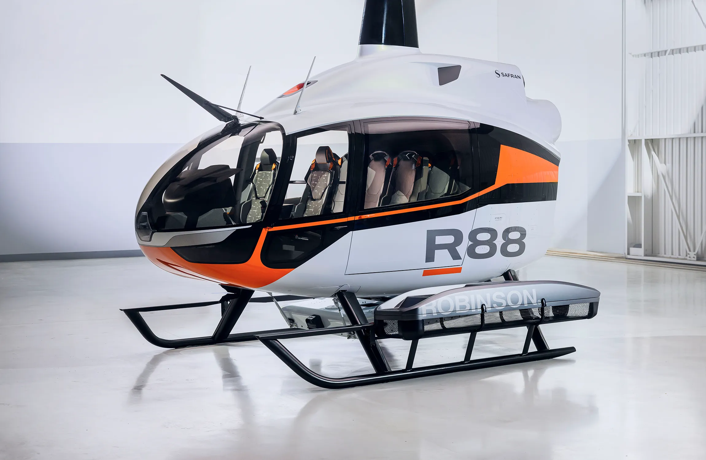 A white helicopter parked in a hangar