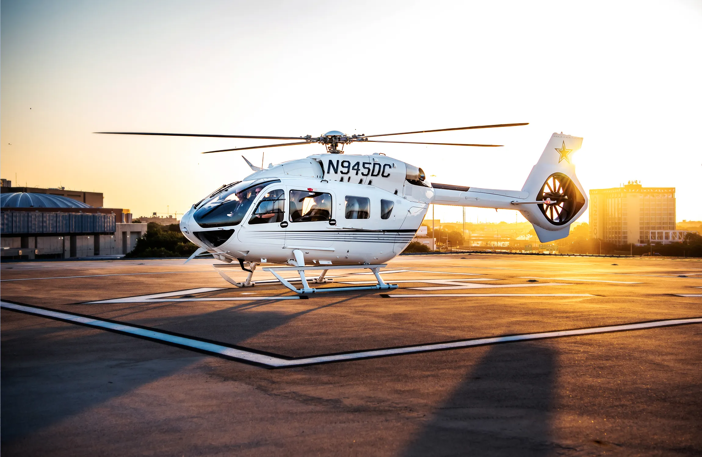 An white helicopter parked on the tarmac